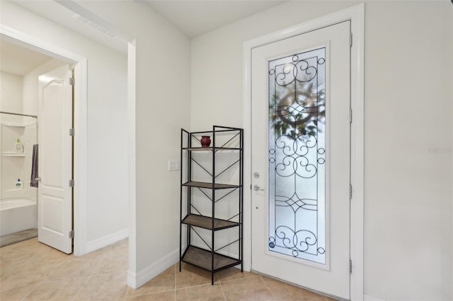 7580 Pool Compass Loop, Wesley Chapel, FL 33545 - entryway featuring light tile patterned flooring, baseboards, and visible vents