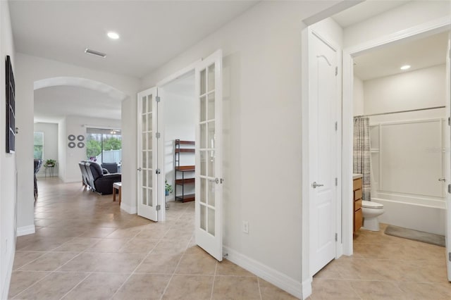 7580 Pool Compass Loop, Wesley Chapel, FL 33545 - hall featuring visible vents, recessed lighting, french doors, arched walkways, and light tile patterned floors
