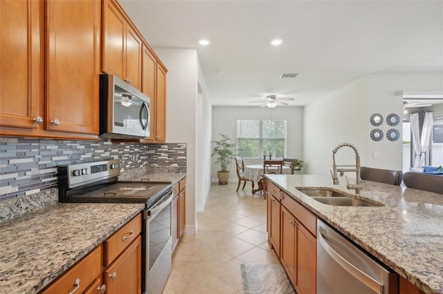 7580 Pool Compass Loop, Wesley Chapel, FL 33545 - kitchen with backsplash, visible vents, appliances with stainless steel finishes, a sink, and light tile patterned floors