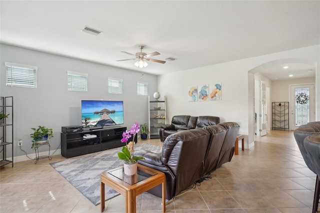 7580 Pool Compass Loop, Wesley Chapel, FL 33545 - tiled living room featuring arched walkways, baseboards, a ceiling fan, and visible vents