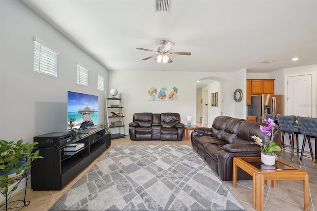 7580 Pool Compass Loop, Wesley Chapel, FL 33545 - living room with visible vents, arched walkways, a ceiling fan, and light tile patterned floors