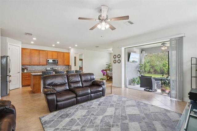 7580 Pool Compass Loop, Wesley Chapel, FL 33545 - living room with light tile patterned floors, a ceiling fan, and visible vents