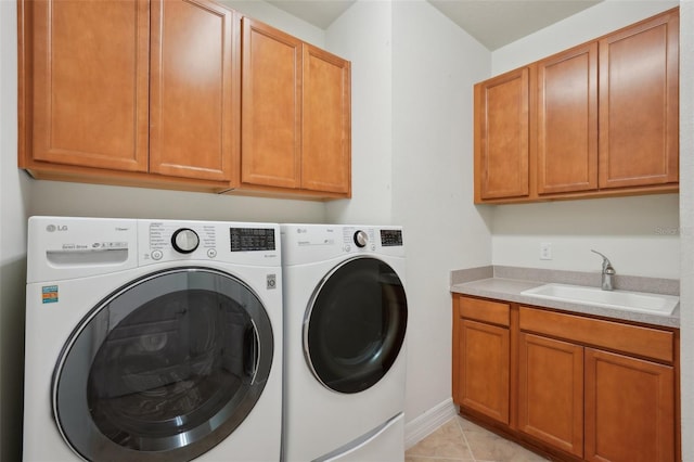 7580 Pool Compass Loop, Wesley Chapel, FL 33545 - washroom featuring cabinet space, separate washer and dryer, light tile patterned floors, and a sink
