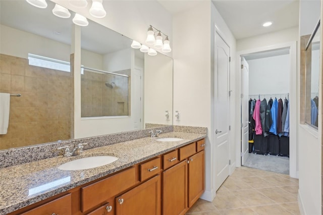 7580 Pool Compass Loop, Wesley Chapel, FL 33545 - full bath featuring a sink, tile patterned flooring, a tile shower, and double vanity