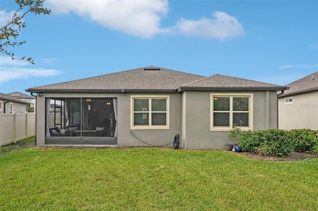 7580 Pool Compass Loop, Wesley Chapel, FL 33545 - back of property featuring fence, a shingled roof, stucco siding, a sunroom, and a lawn