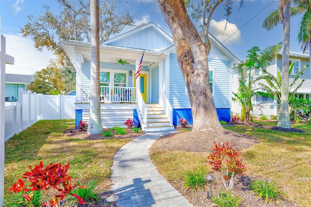 bungalow-style home with a front lawn and covered porch