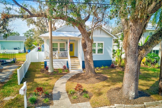 bungalow-style house featuring a porch and a front yard