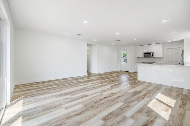 unfurnished living room with light wood-type flooring