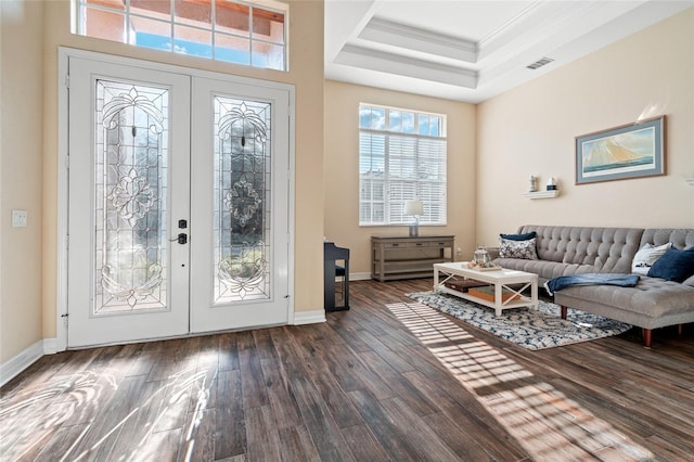 entryway with dark hardwood / wood-style flooring, crown molding, french doors, and a raised ceiling