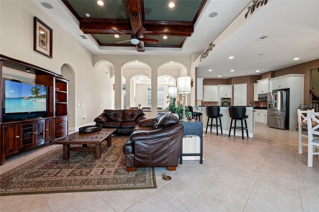 living room featuring beamed ceiling, ceiling fan, coffered ceiling, and light tile patterned floors