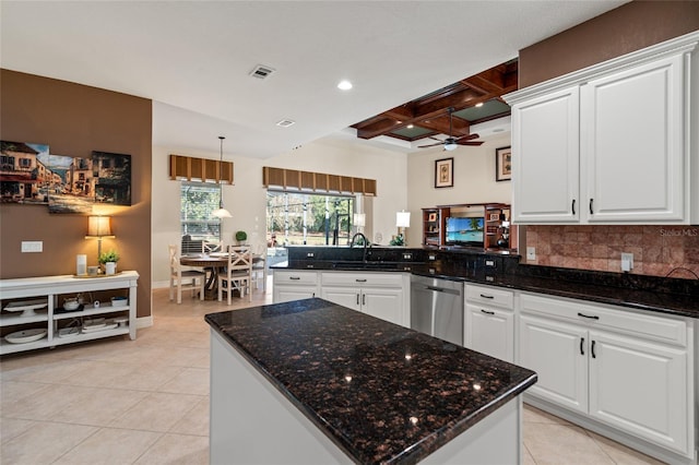 kitchen with sink, coffered ceiling, white cabinets, stainless steel dishwasher, and kitchen peninsula