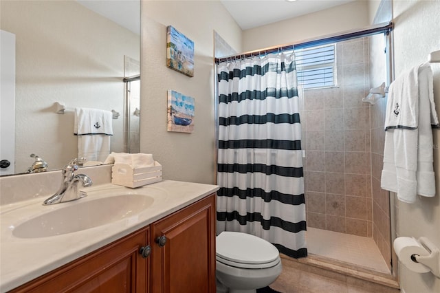 bathroom with walk in shower, vanity, and toilet