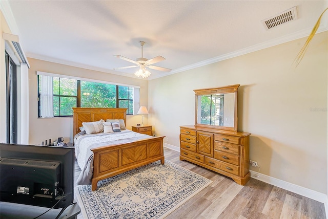 bedroom featuring ceiling fan, ornamental molding, light hardwood / wood-style floors, and multiple windows