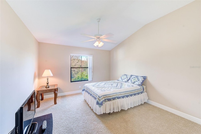 bedroom with vaulted ceiling, light colored carpet, and ceiling fan