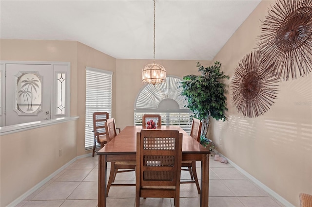 tiled dining area with an inviting chandelier