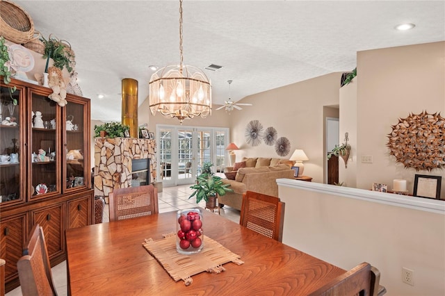 dining space featuring lofted ceiling, a textured ceiling, and a chandelier