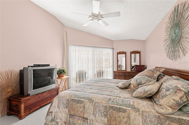 bedroom featuring lofted ceiling, ceiling fan, a textured ceiling, and carpet flooring