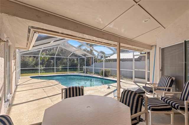 view of swimming pool featuring a lanai and a patio area