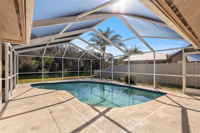 view of pool with a patio area and glass enclosure