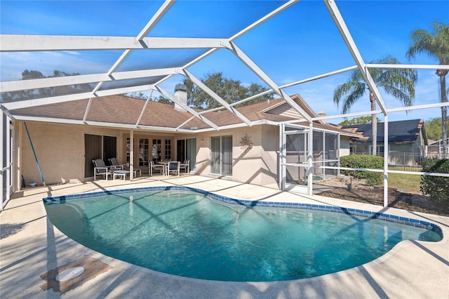 view of pool with a lanai and a patio