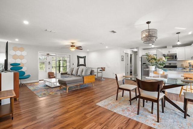 dining space featuring ceiling fan and dark hardwood / wood-style flooring