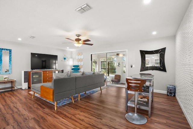 living room with ceiling fan and dark hardwood / wood-style floors