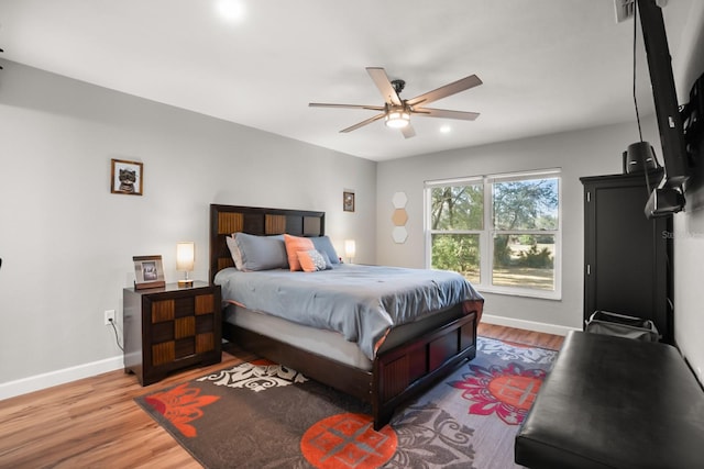 bedroom with ceiling fan and hardwood / wood-style floors