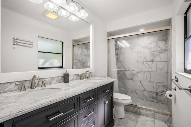 bathroom with vanity, toilet, and a shower with door