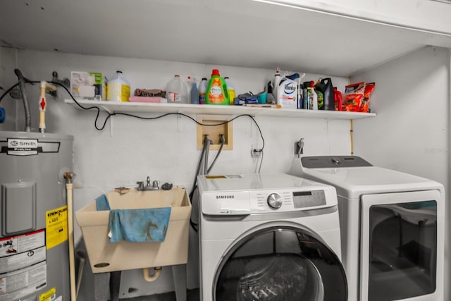 clothes washing area with independent washer and dryer, sink, and water heater