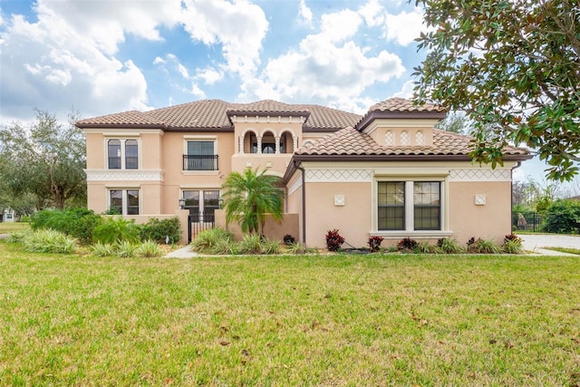 mediterranean / spanish home with a front yard