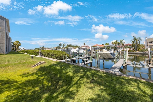 dock area featuring a water view and a lawn