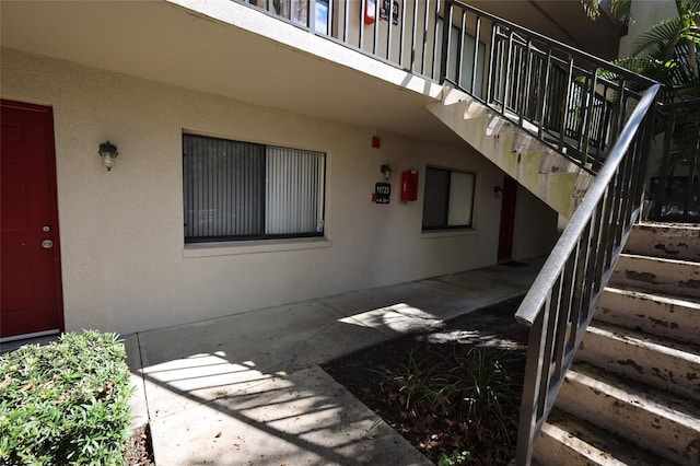 entrance to property with stucco siding