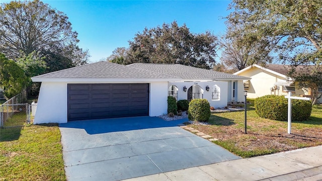 single story home featuring a garage and a front yard