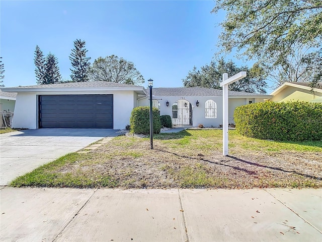 single story home with a garage and a front lawn