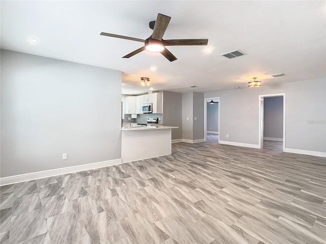 unfurnished living room featuring ceiling fan