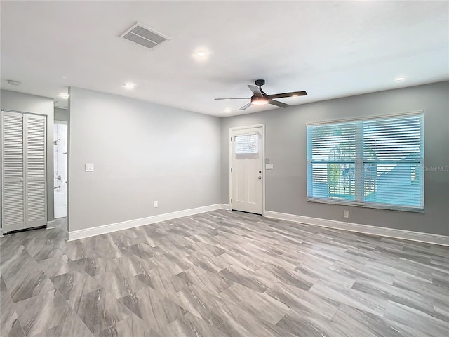 foyer entrance featuring ceiling fan