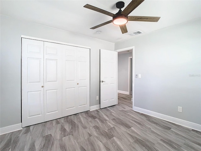 unfurnished bedroom featuring a closet and ceiling fan