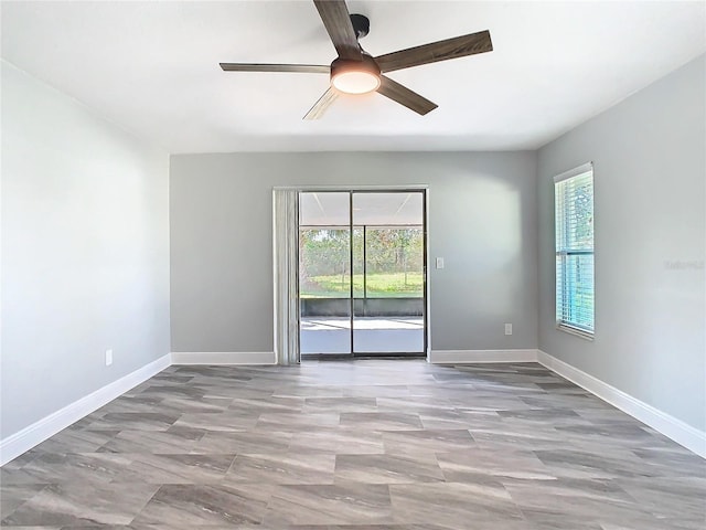 spare room with ceiling fan and a healthy amount of sunlight