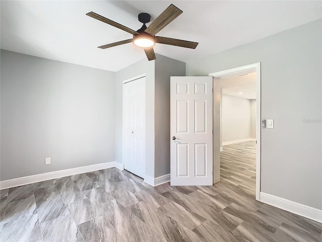 unfurnished bedroom with ceiling fan, light hardwood / wood-style floors, and a closet