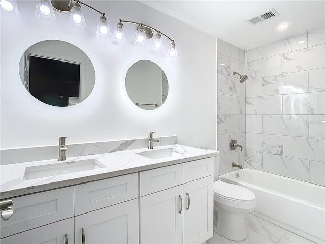 full bathroom with vanity, toilet, and tiled shower / bath combo