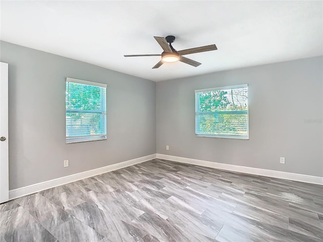 empty room with a wealth of natural light and ceiling fan