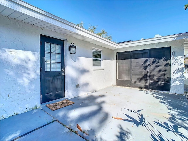 entrance to property with a patio