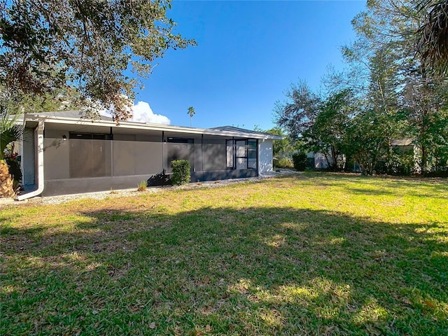 rear view of house with a yard