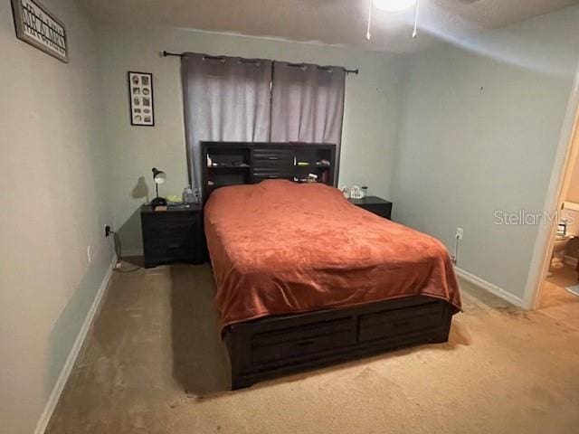 bedroom featuring ceiling fan and carpet