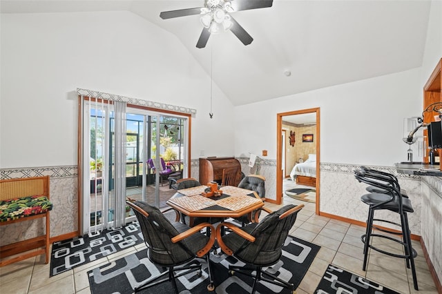 dining area featuring ceiling fan, high vaulted ceiling, and light tile patterned floors