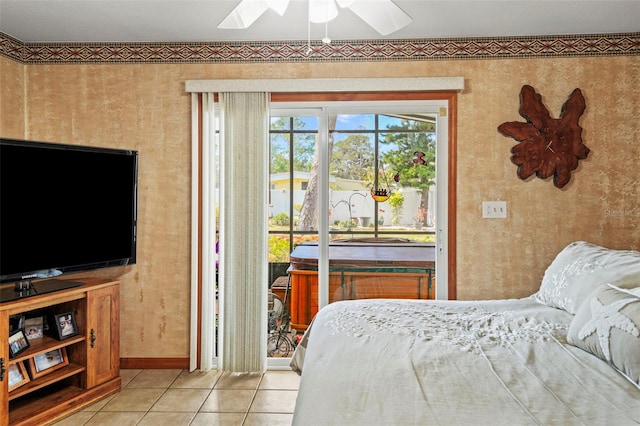 tiled bedroom with ceiling fan and access to exterior