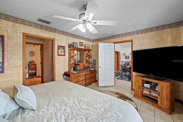 tiled bedroom featuring ceiling fan