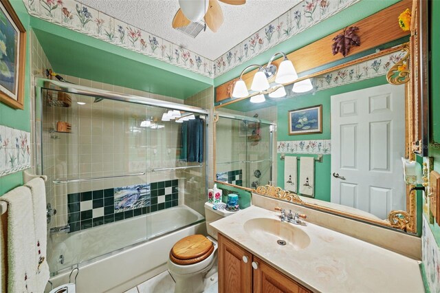 full bathroom featuring enclosed tub / shower combo, ceiling fan, vanity, a textured ceiling, and toilet