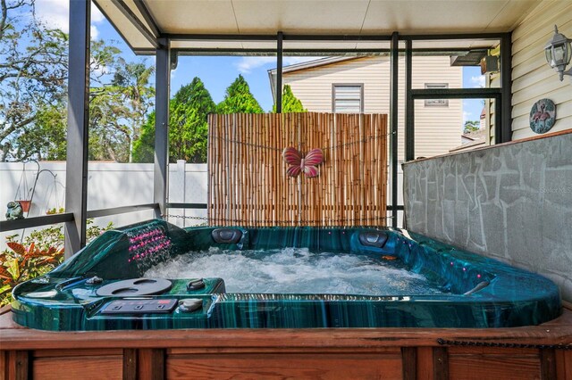 sunroom / solarium featuring a jacuzzi