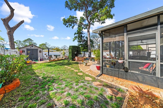 view of yard with a patio, a shed, and a sunroom